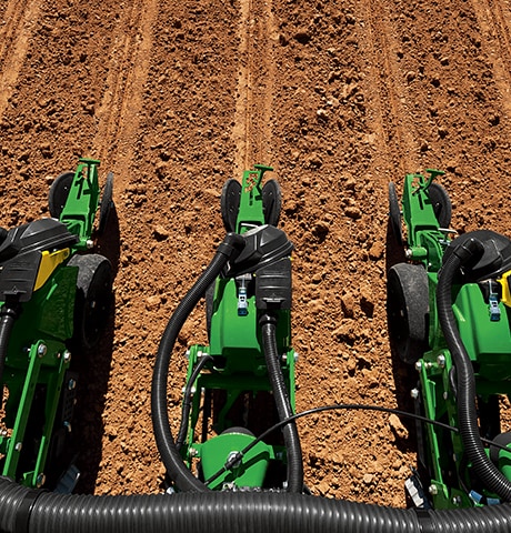 Planting og såing i en åker med en John Deere-såmaskin i 1700-serien