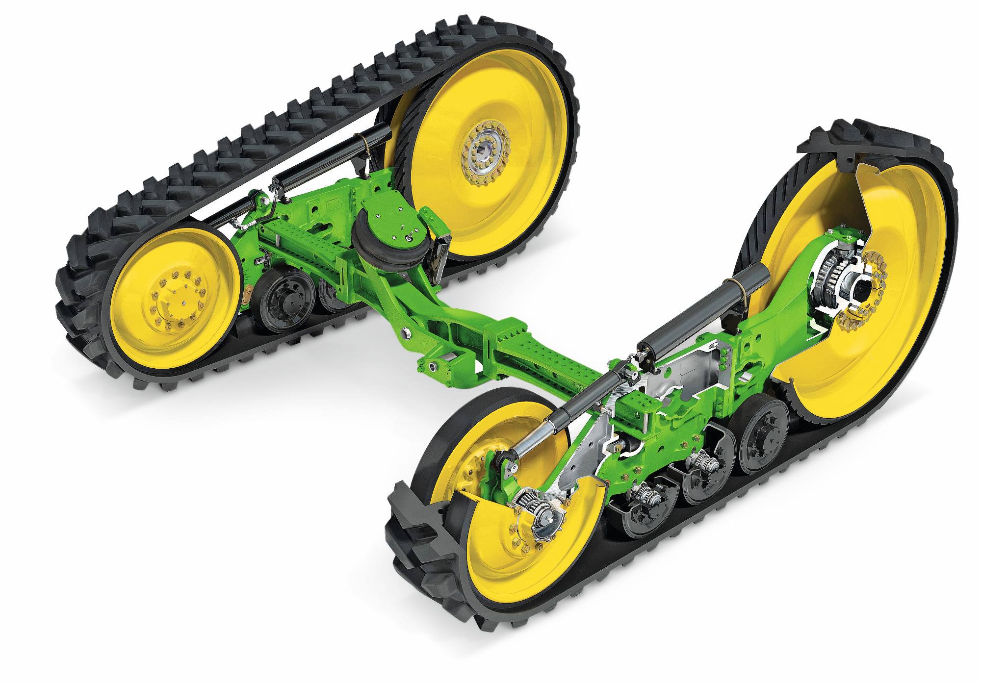 John Deere-belter med gummibelter, fjæringsarmer og gule drivhjul, vist på hvit studiobakgrunn.